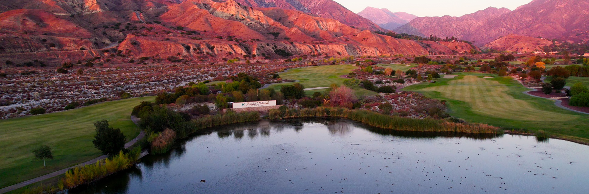 view of golf course with mountains in background